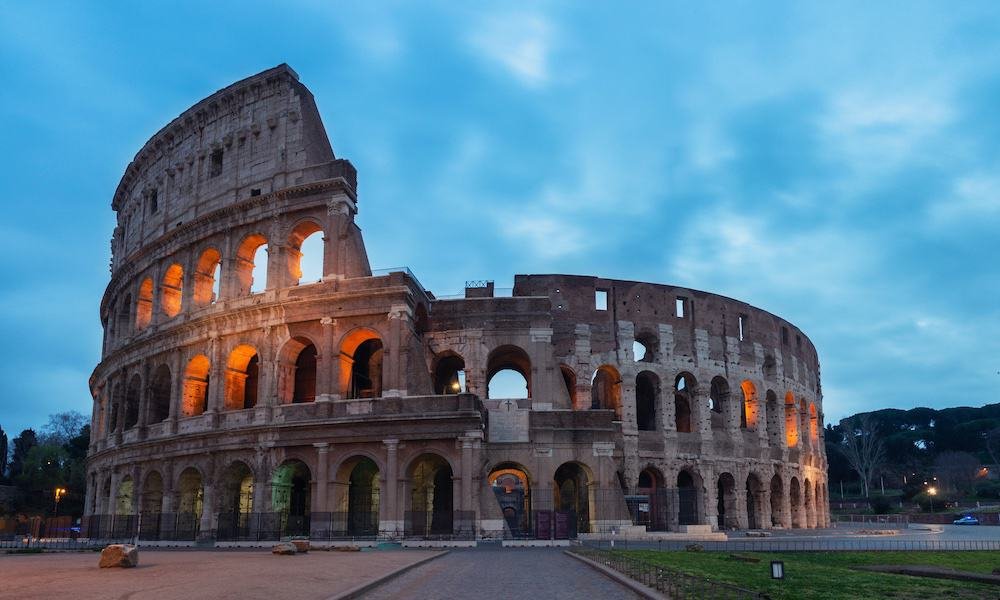 The Colosseum in Rome at blue hour, lit from outside